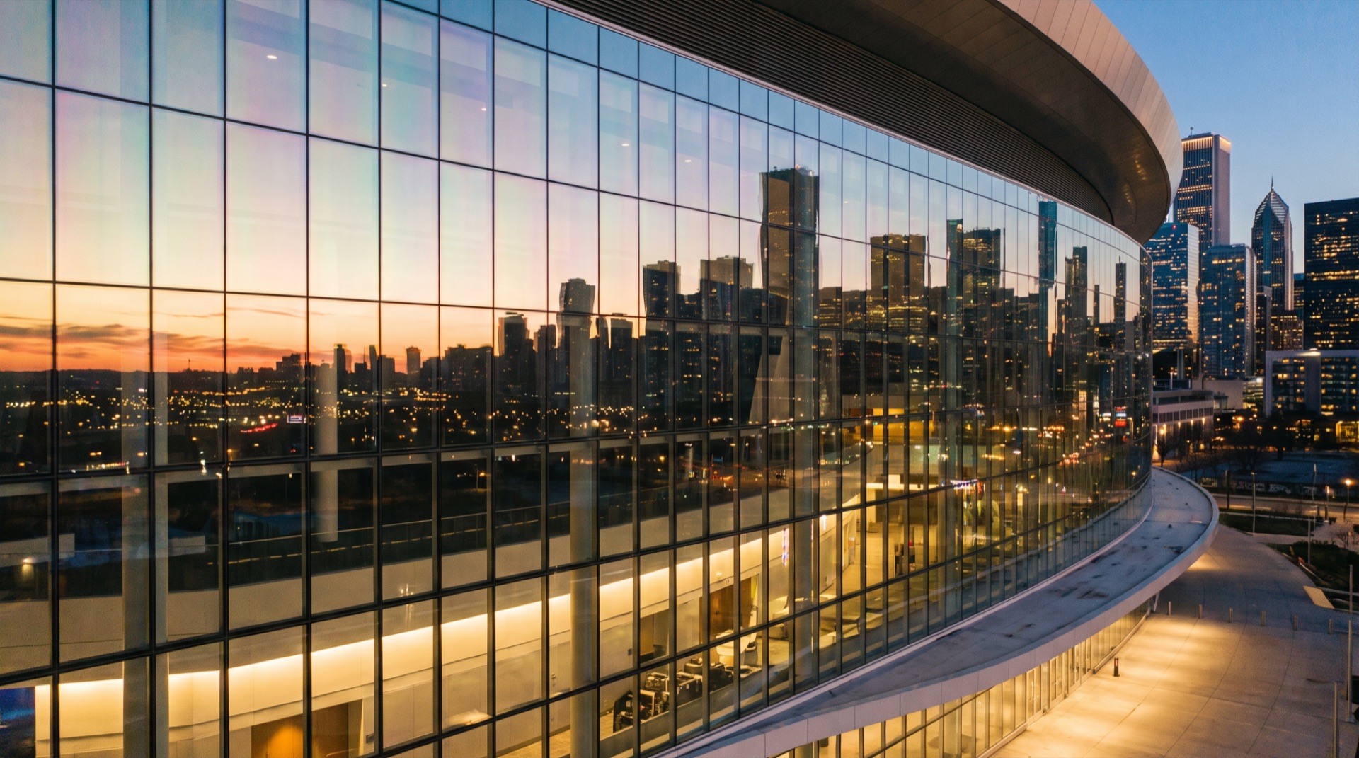 Modern arena exterior glass facade at dusk with energy-efficient window film