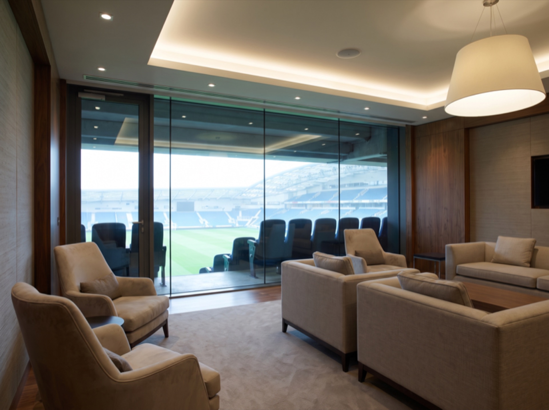 Arena VIP suite with glare control window film — comfortable diffused light through treated glass