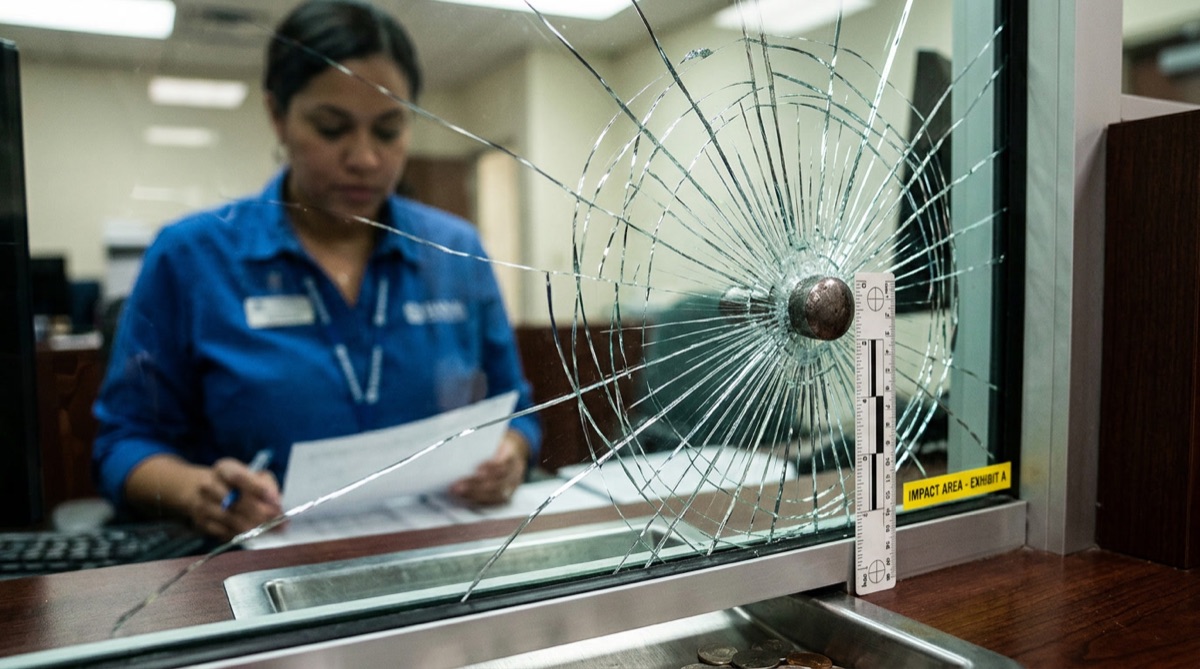 Security window film on bank teller glass showing impact resistance with glass held together by thick film for Philadelphia secured facility