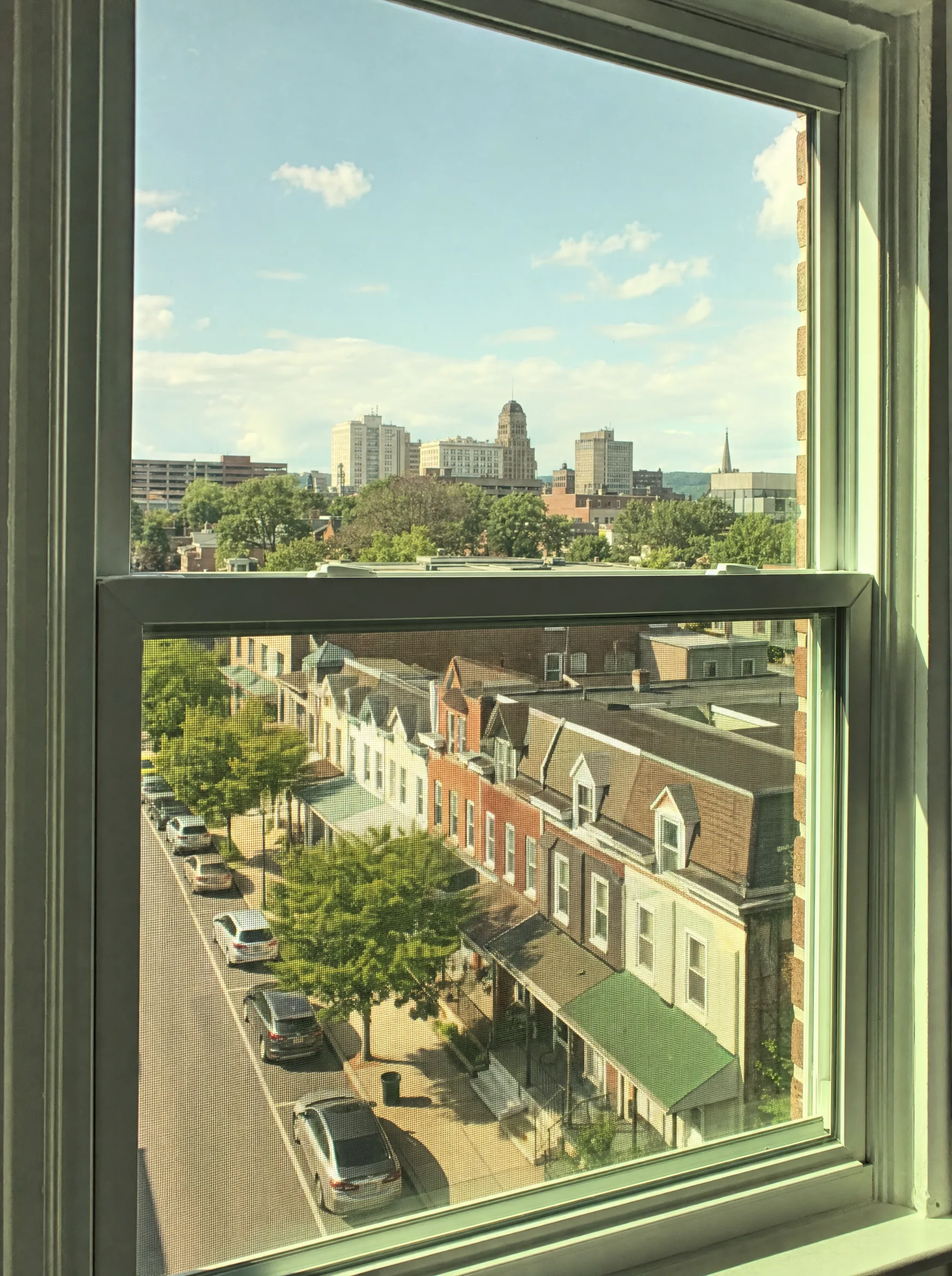 Allentown skyline and rowhome neighborhoods along the Lehigh River — Allentown's summer heat and river-valley humidity make window film essential